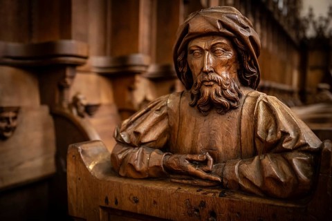 Carved half-figure, man with beard, oak choir stalls for monks' hour prayers, 1493 by Jörg Syrlin