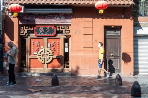 Tourists stroll in Chinatown in front of a Chinese restaurant, Buenos Aires, Argentina