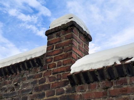 Snowy brick wall against blue winter sky, Wuppertal, Germany