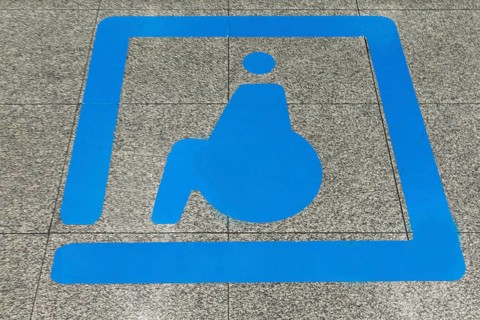 Sign for disabled people in front of a baggage carousel at the airport, Krakow, Poland