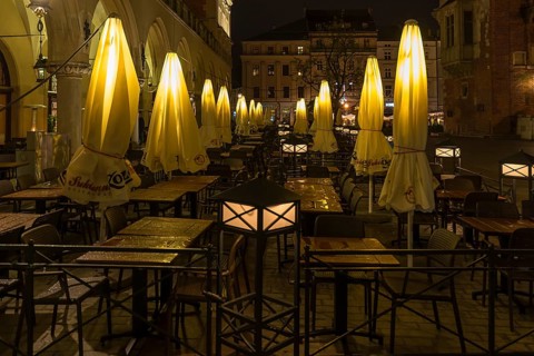Illuminated umbrellas in a restaurant on the market square at night, Krakow, Poland