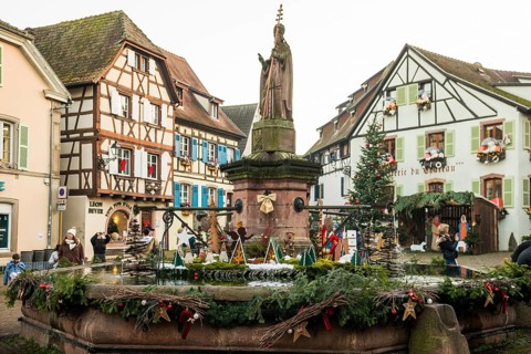 Christmassy decorated houses and fountains with half-timbered houses, Christmas market, Eguisheim,