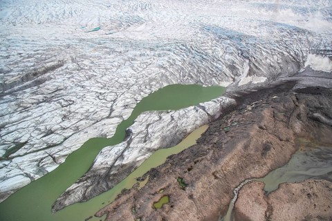 Aerial view of coast and Greenland ice sheet, Arctic landscape, frozen wilderness, glaciers and
