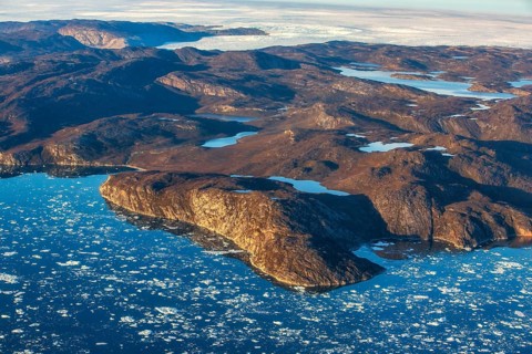 Aerial view of the coast and Greenland ice sheet, Arctic landscape, frozen wilderness, glaciers and