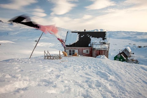 On a winter morning, laundry hanging in the wind outside a house in the village of Tiniteqilaaq.