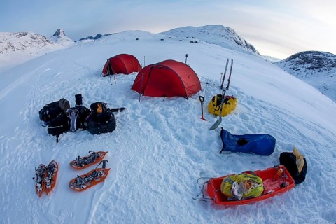 Tourists camp in a winter Arctic expedition skiing along Ikasartivaq Fjord, Sermersooq