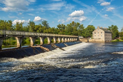 Moulin Neuf water flow control dam and walkway over Des Mille-Iles river plus New Mill on Ile des