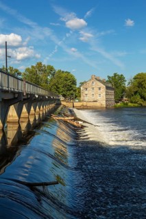 Moulin Neuf water flow control dam and walkway over Des Mille-Iles river plus New Mill on Ile des