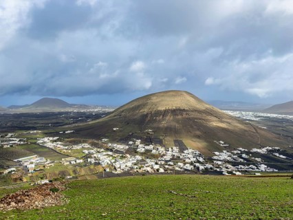 View from Montaña Blanca mountain to the town of Montaña Blanca with cloudy sky in the background,