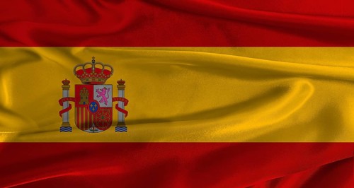 Flag of Spain with fabric textured background. Close up of National flag of Spain with realistic