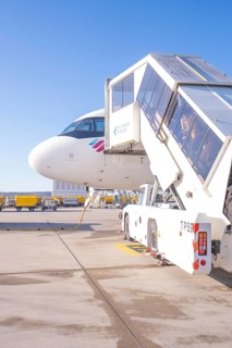Close-up of an airplane with mobile stairs in the sunshine on the airport apron, Stuttgart Airport,
