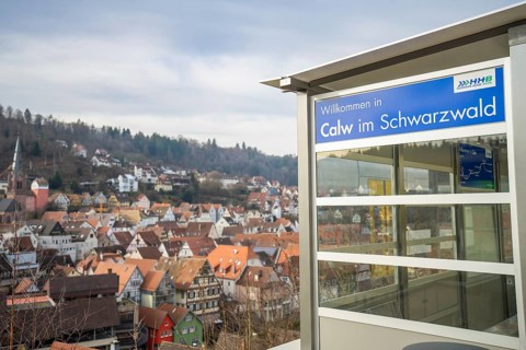 A Calw sign with a picturesque view of a village in the Black Forest, taking off the Hermann