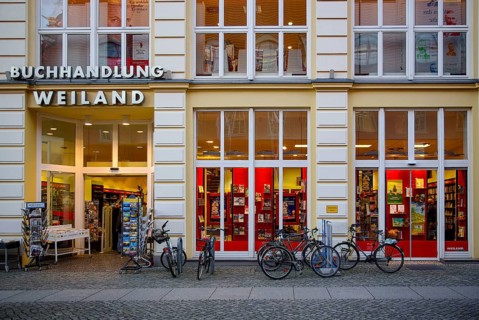 Weiland bookstore with bicycles parked in front of it, at the fish market in the Hanseatic City of