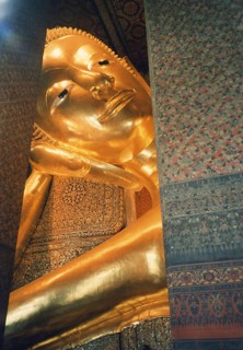 Reclining Buddha in Wat Po. The reclining Buddha symbolizes the last earthly hours in front of