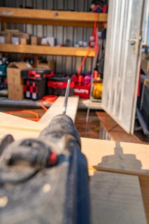 Close-up of a drill in a workshop environment with shelves and order, carpentry, new building,