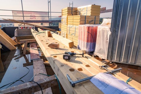 Construction site with wood and tools. Stack of building materials in bright sunlight, carpentry,