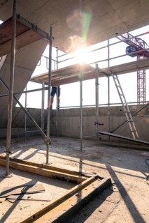 Construction site scene with scaffolding and sunlight, construction worker working on construction,
