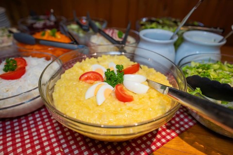 Buffet menu with potato salad and various side dishes served in bowls