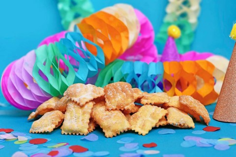 Rhenish pastries called 'Mutzen pastries or Muzenblätter' with powdered sugar on festive background