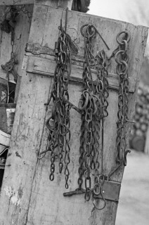 Cow chains on a cupboard door in the courtyard, Täuberhof, on a former Franconian farm, black and
