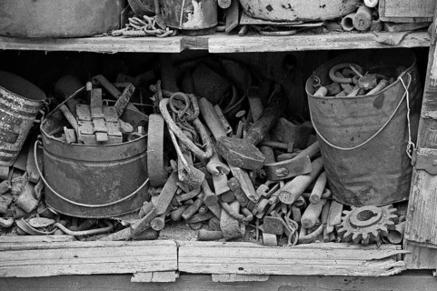 Collection of tools in an old cupboard in the courtyard, on a former Franconian farm, black and