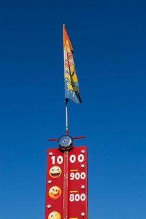 Close-up of High Striker game of strength with numbered score levels at Fun Show traveling