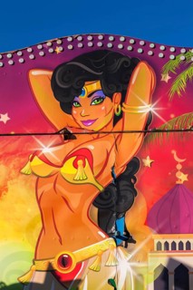 Colourful illustration of voluptuous green eyed Arabian belly dancer painted on amusement ride at