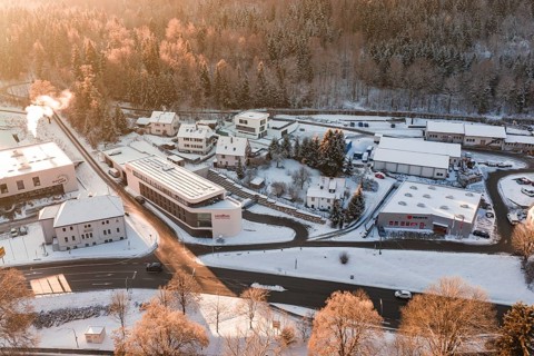 Snowy buildings and roads in an industrial and residential area during winter, Nagold, Calw