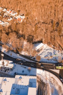 Snowy road junction on the edge of a forest with adjacent buildings, Nagold, Calw district, Black