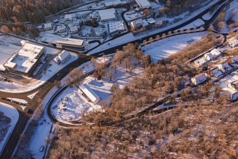 Bird's eye view of a snowy winter landscape with roads, buildings and forests, Nagold, Calw