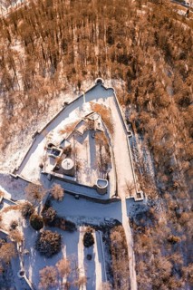 Aerial view of a snowy castle with a triangular layout surrounded by trees, Nagold, Calw district,