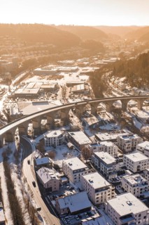 Viaduct over snow-covered residential areas in a city, with hills in the background, Nagold, Calw