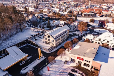 Building and gas station in a snowy urban landscape, Nagold, Calw district, Black Forest, Germany