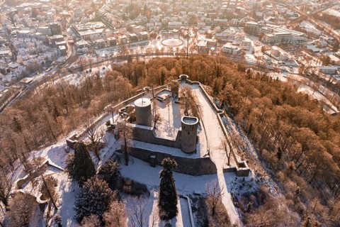 Panoramic view of a snowy castle with city in the background, surrounded by trees, Nagold, Calw