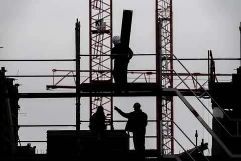 Construction site, scaffolding work on a large construction project, apartments and commercial