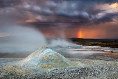 Thunderstorm and rainbow over the Hveravellir geothermal area with natural hot springs and