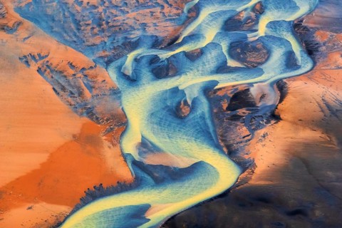 Aerial view of the colorful Þjórsá River, Iceland's longest river, weaving through volcanic