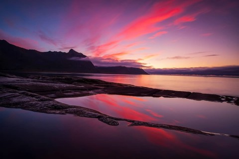 Coastal view in Senja, Norwegian Sea, rugged cliffs and mountains composed mainly of Precambrian