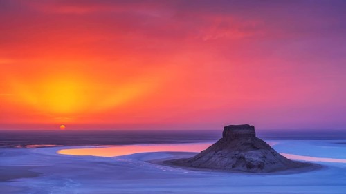 Sunset at Karynzharyk Depression with Mount Karamaya rising above the salt plain, unique saline