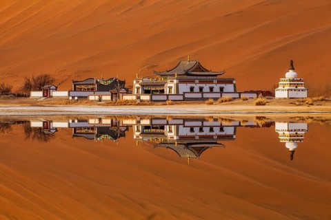 Reflection of Badain Jaran Temple by the shore of a lake, Tibetan-Buddhist temple, Badain Jaran