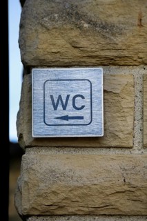 WC sign, signpost on wall, cemetery of Großengstingen, writing, letters, arrow, Großengstingen,