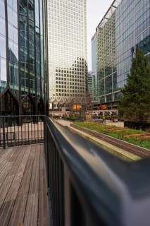 Modern, tall buildings with glass facades in an urban environment with trees, London, England,