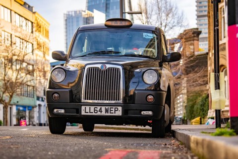 A black London taxi parked on a city street, London, England, Great Britain