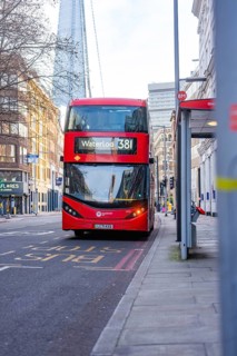 A red double-decker bus travels through the streets of London, London, England, Great Britain