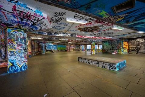 Colourful graffiti covering an underpass in an urban setting, London, England, Great Britain