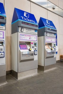 Row of blue and silver ticket machines in a train station, London, United Kingdom