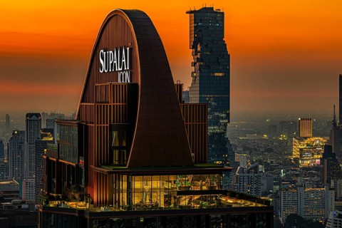 Over the rooftops of Bangkok, sunset, roof structure of the luxury residential residence Supalai