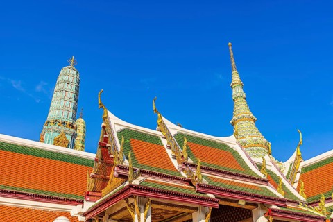 The Grand Royal Palace, Wat Phra Kaeo Buddhist Temple, overlapping roofs with curved chofas, Chedi