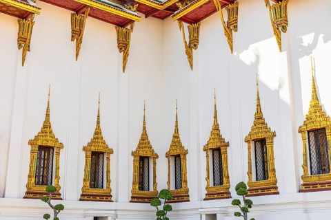The Grand Royal Palace, richly decorated and gilded windows at the Dusit Maha Prasad throne hall,