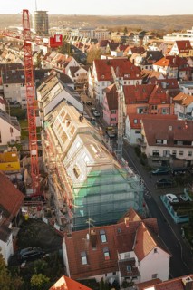 Bird's eye view of a residential area with construction site in the midst of numerous residential
